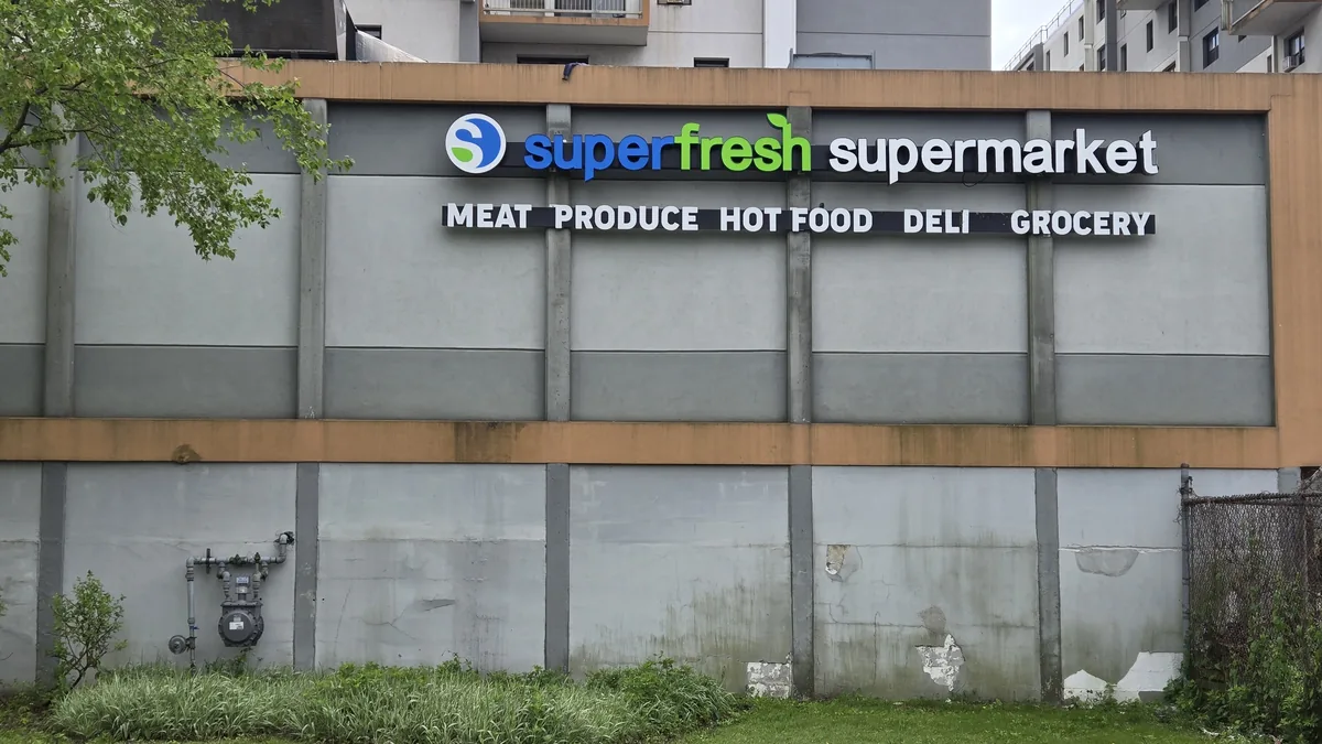 SuperFresh Supermarket sign listing meat, produce, hot food, deli and grocery departments